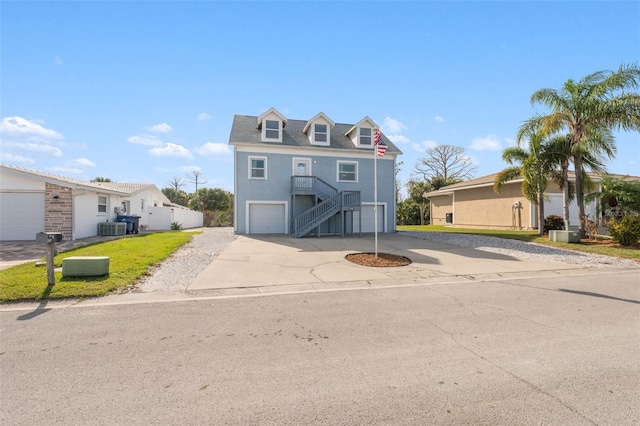 4148 Rudder Way, New Port Richey, FL 34652 - coastal home featuring stairs, concrete driveway, a garage, central air condition unit, and stucco siding