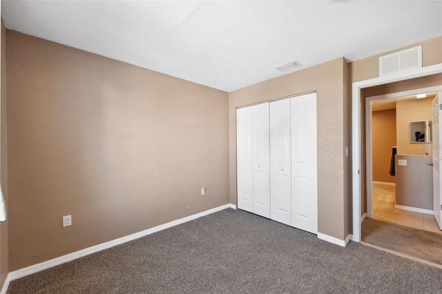 4148 Rudder Way, New Port Richey, FL 34652 - unfurnished bedroom featuring dark colored carpet and a closet