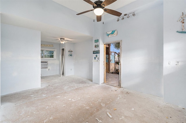 spare room featuring a wall mounted air conditioner and ceiling fan