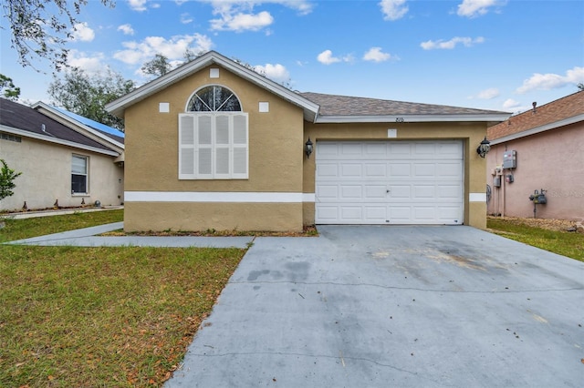 view of front of house featuring a front lawn and a garage