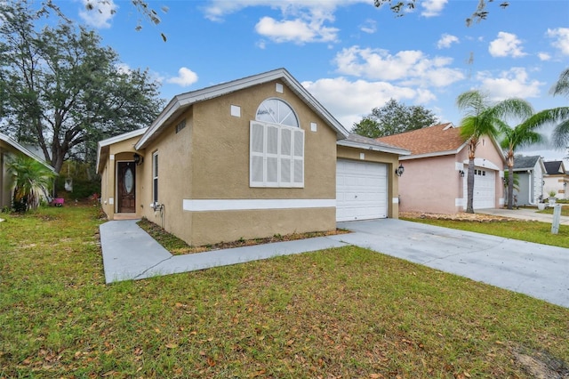 view of front of home with a garage and a front lawn