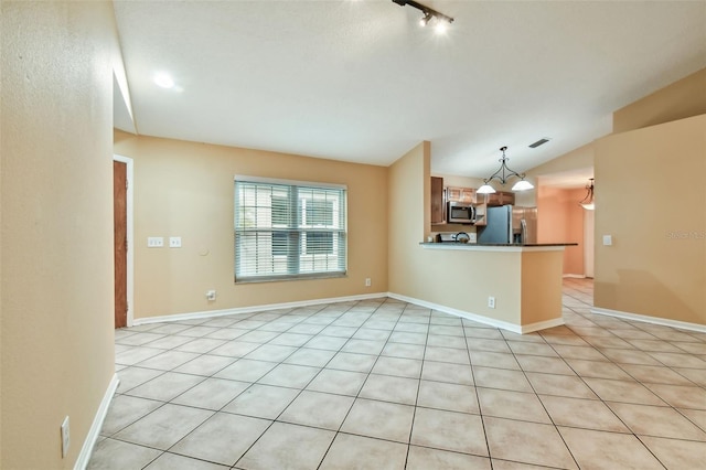 unfurnished living room with lofted ceiling and light tile patterned flooring