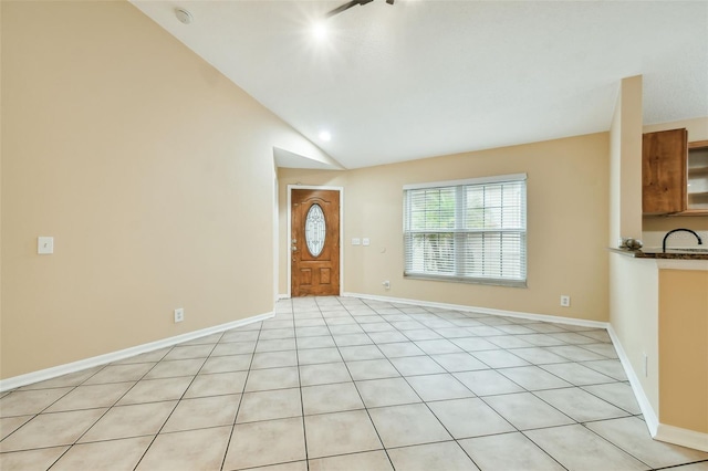 tiled entryway featuring lofted ceiling