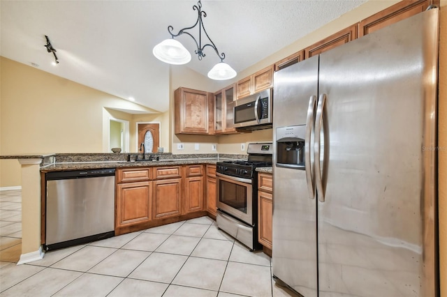 kitchen featuring sink, hanging light fixtures, kitchen peninsula, light tile patterned floors, and appliances with stainless steel finishes