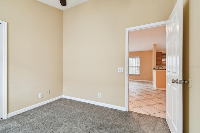 carpeted empty room with ceiling fan