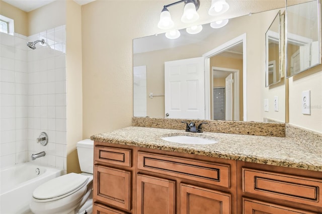 full bathroom with vanity, toilet, and tiled shower / bath