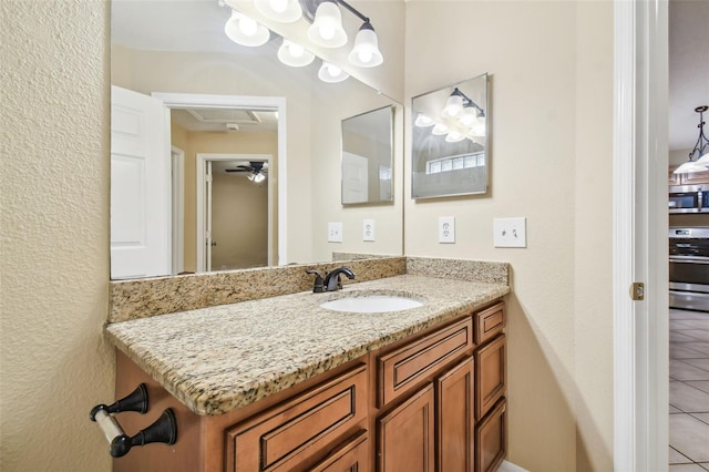 bathroom featuring tile patterned floors, vanity, and ceiling fan