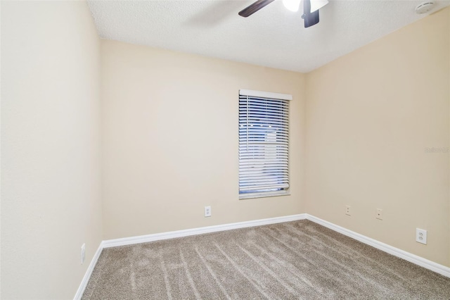 empty room featuring light carpet, a textured ceiling, and ceiling fan