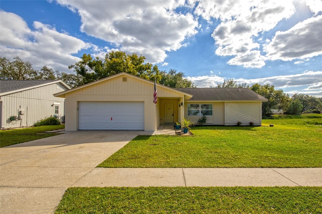 ranch-style house featuring a front yard and a garage