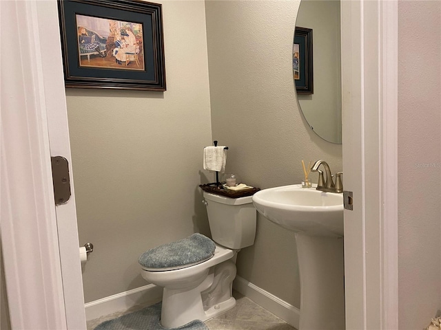 bathroom featuring tile patterned flooring and toilet