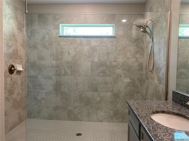 bathroom featuring vanity and a tile shower