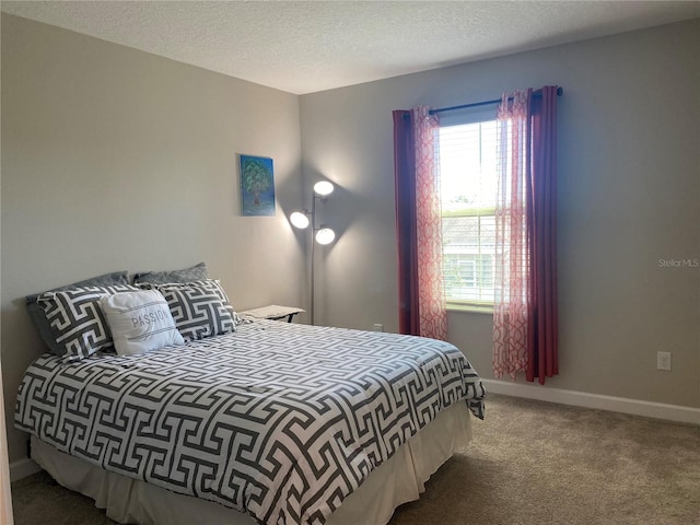 bedroom with carpet floors and a textured ceiling