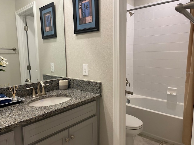 full bathroom with tiled shower / bath combo, toilet, and vanity