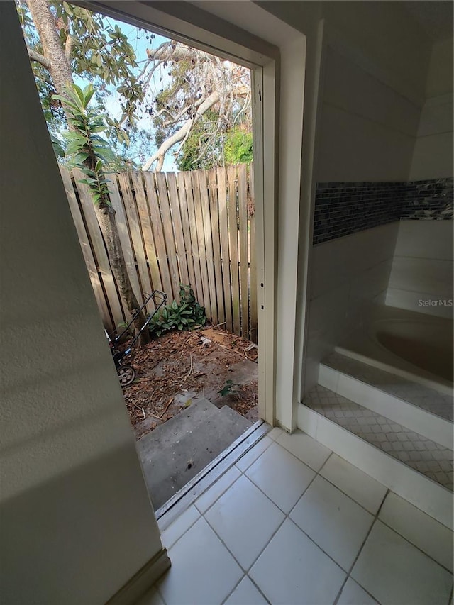 doorway to outside with tile patterned flooring