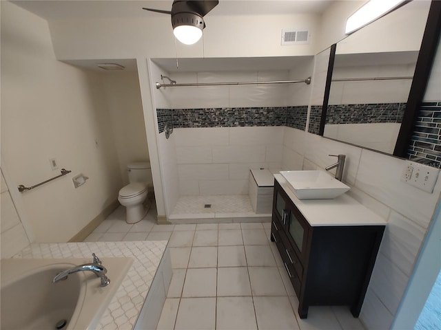 full bathroom featuring toilet, vanity, tile patterned floors, and independent shower and bath