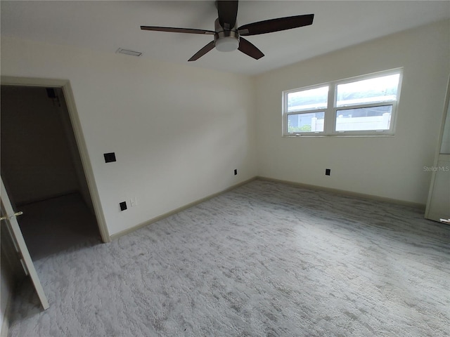 carpeted empty room featuring ceiling fan