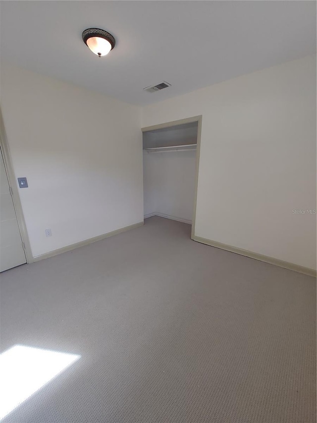 unfurnished bedroom featuring a closet and carpet