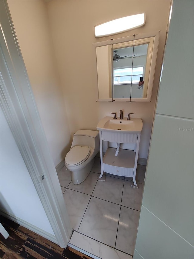 bathroom featuring tile patterned floors, toilet, and ceiling fan