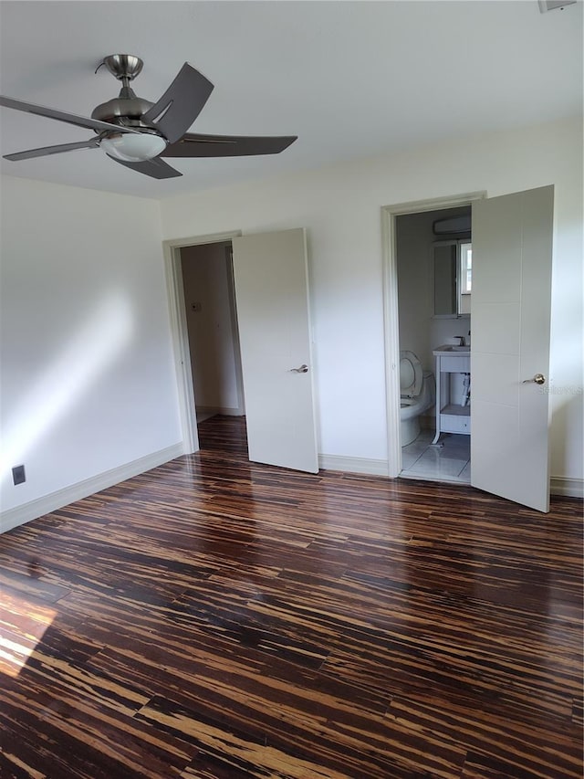 spare room with ceiling fan and dark wood-type flooring