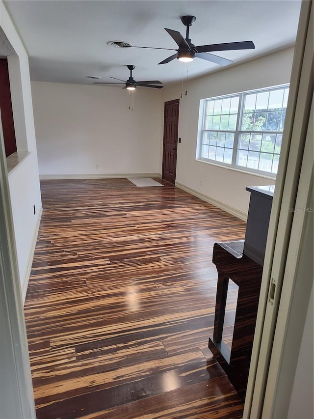 spare room featuring dark hardwood / wood-style floors and ceiling fan