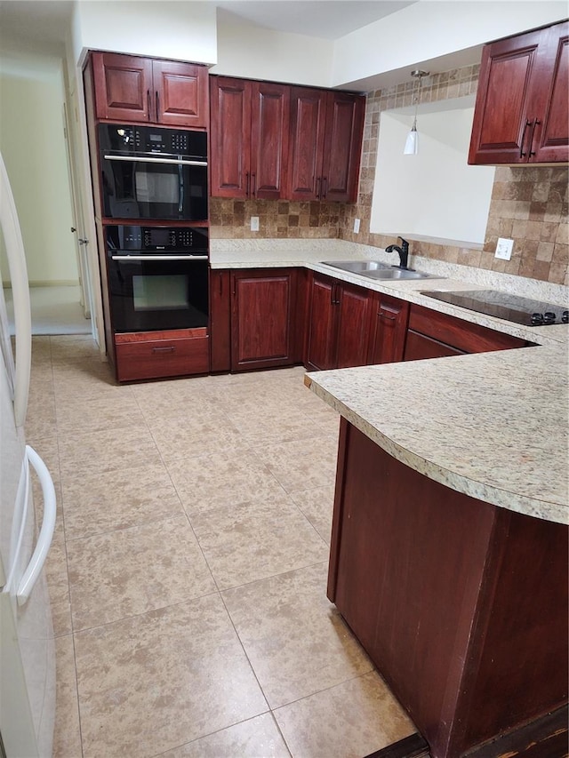 kitchen with sink, hanging light fixtures, backsplash, light tile patterned floors, and black appliances