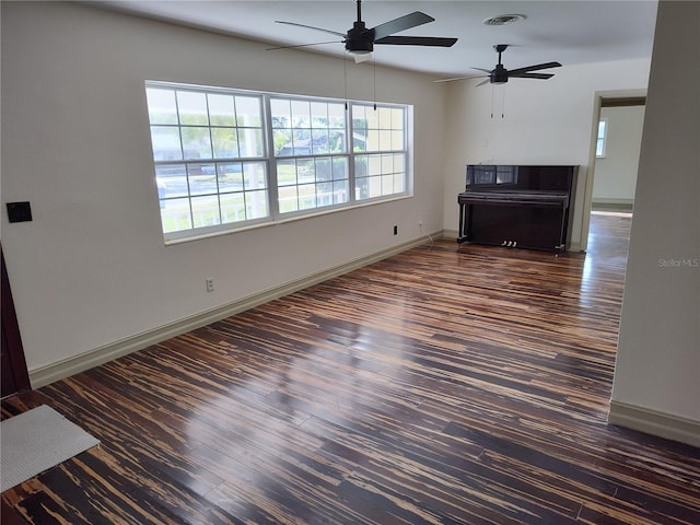 unfurnished living room with ceiling fan and dark hardwood / wood-style floors