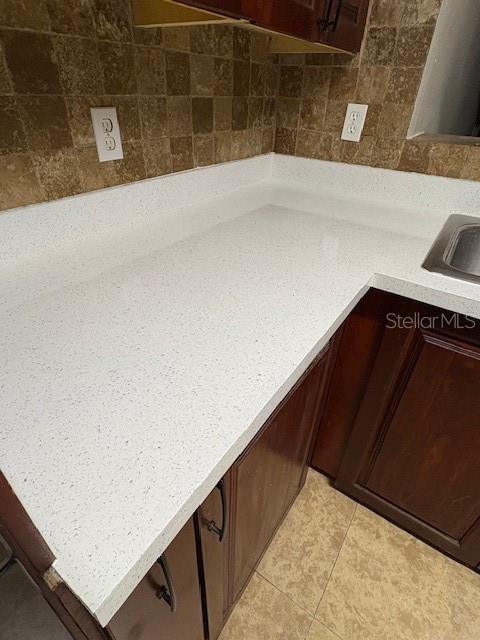 interior details with dark brown cabinets and sink