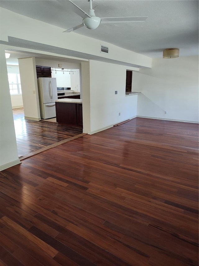 empty room featuring dark hardwood / wood-style flooring and ceiling fan