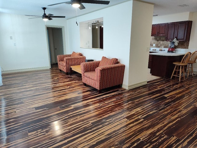 living room featuring dark hardwood / wood-style flooring and ceiling fan