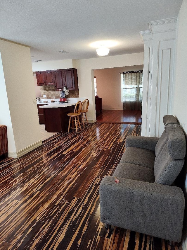 living room with dark hardwood / wood-style flooring and a textured ceiling