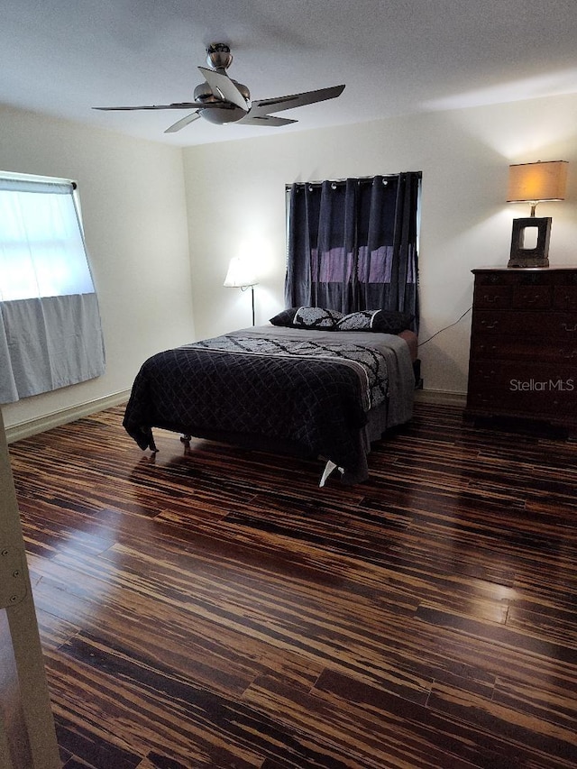 bedroom with ceiling fan and dark hardwood / wood-style flooring