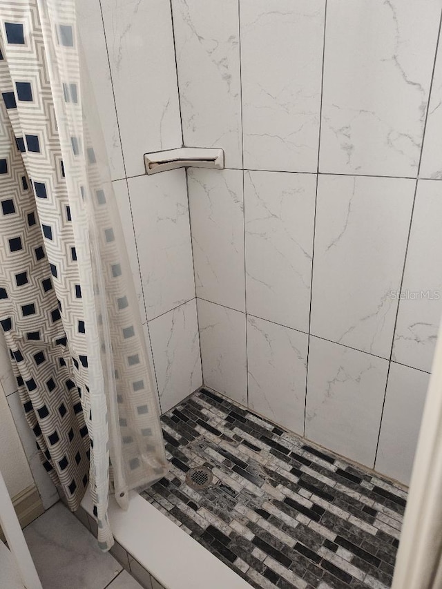 bathroom featuring tile patterned floors and curtained shower