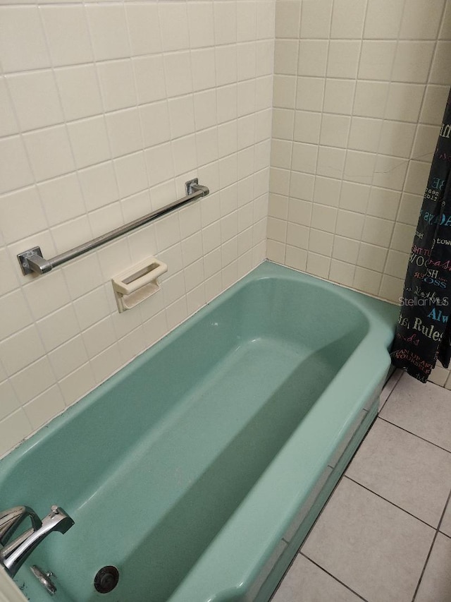 bathroom featuring tile patterned flooring and shower / tub combo with curtain