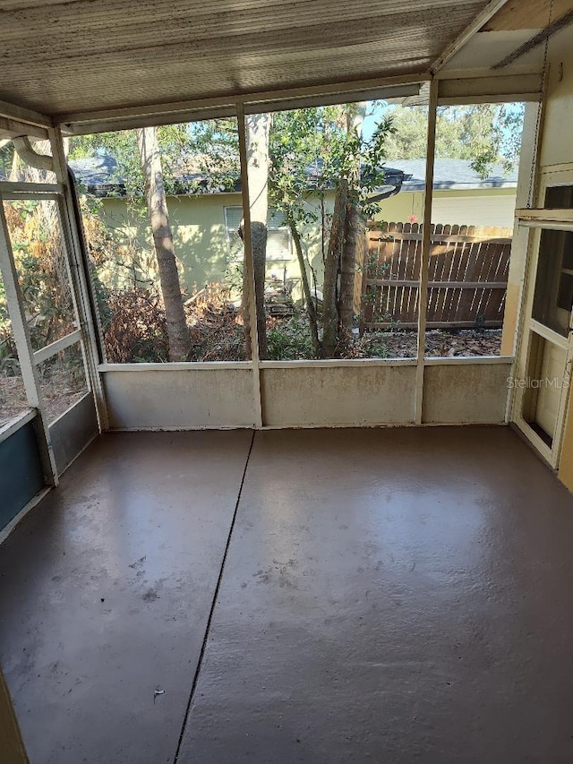 unfurnished sunroom featuring a water view