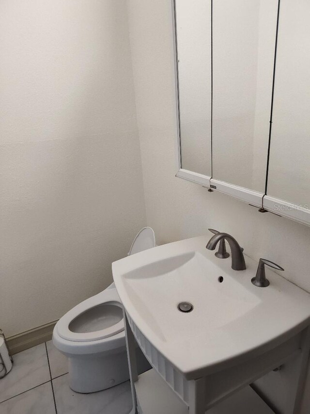 1182 Norwood Ave, Clearwater, FL 33756 - half bathroom with tile patterned flooring and vanity