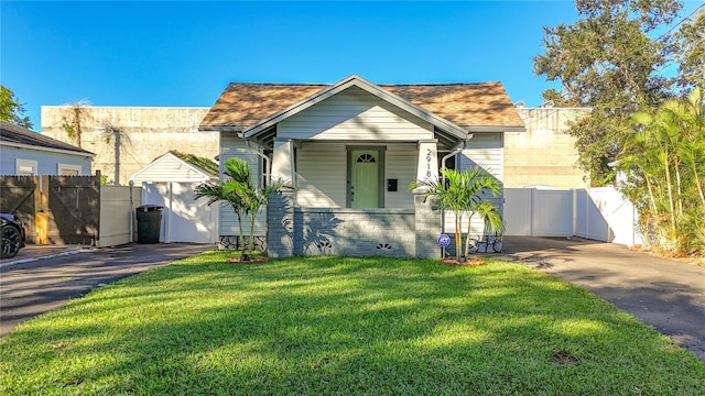 bungalow-style home with a front lawn