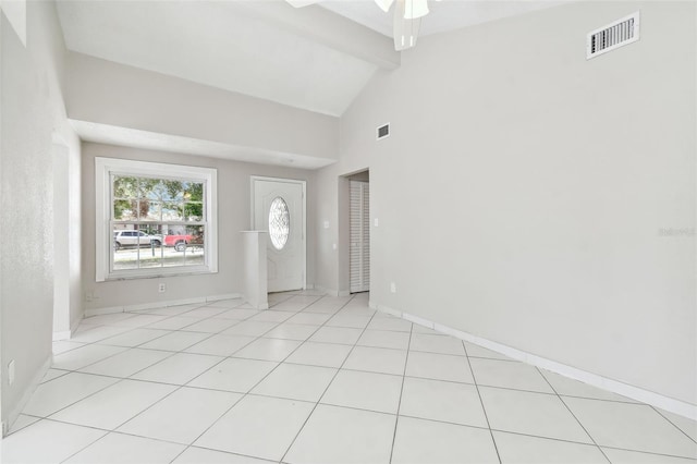 tiled entryway featuring ceiling fan, beam ceiling, and high vaulted ceiling