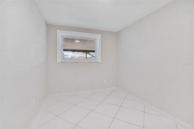 spare room featuring light tile patterned flooring