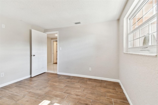 empty room featuring a textured ceiling