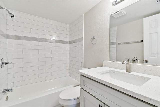 full bathroom featuring vanity, toilet, and tiled shower / bath combo