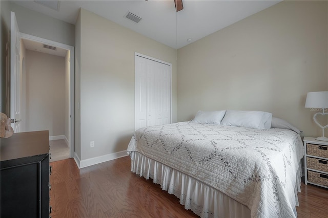 bedroom with dark hardwood / wood-style floors, a closet, and ceiling fan