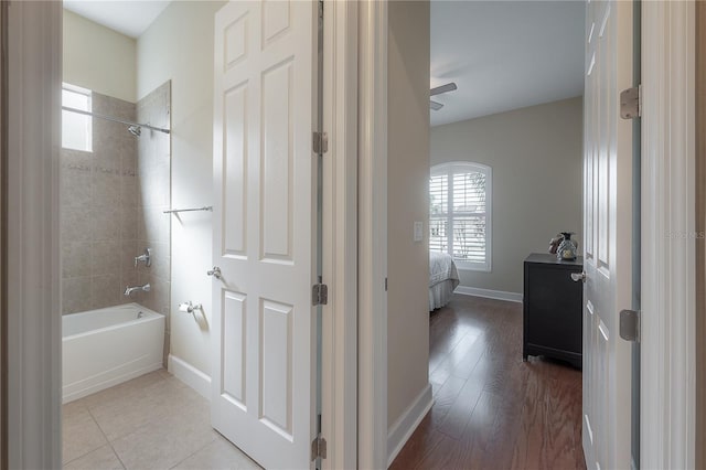 bathroom with wood-type flooring and tiled shower / bath combo