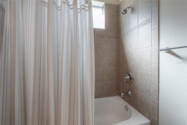 bathroom with shower / bath combination with curtain