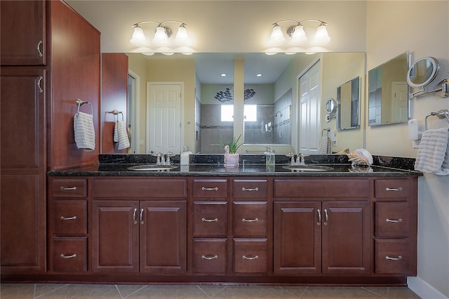 bathroom featuring tile patterned floors, vanity, and walk in shower