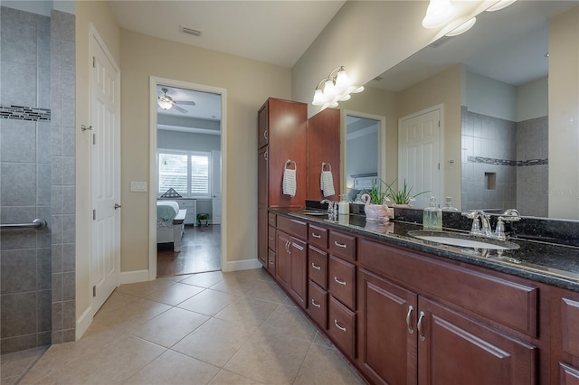 bathroom with tile patterned floors, vanity, ceiling fan, and a tile shower