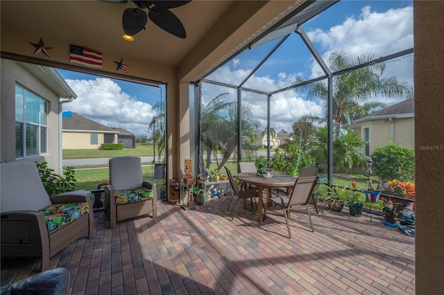 sunroom / solarium featuring ceiling fan