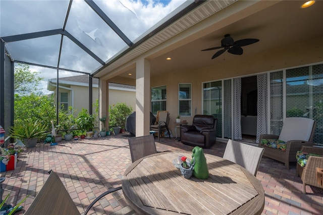 view of patio / terrace with ceiling fan and a lanai