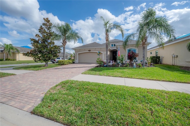 mediterranean / spanish-style house featuring a garage and a front yard