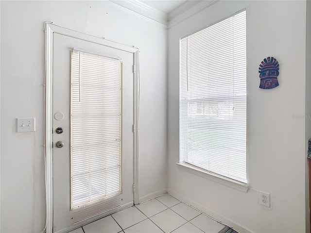 entryway with light tile patterned flooring and ornamental molding