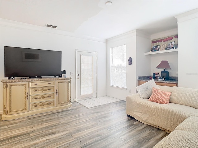 living room featuring light hardwood / wood-style floors and ornamental molding